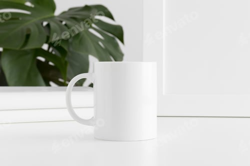 Preview: Mug mockup with workspace accessories and a monstera plant.