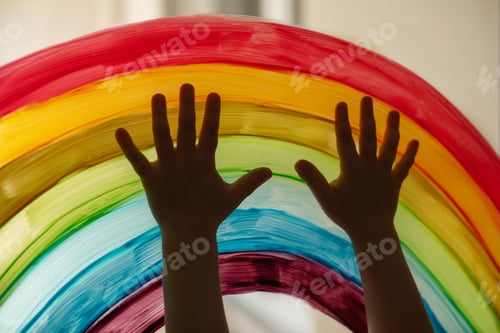 Preview: Child's hands touch painting rainbow on the window