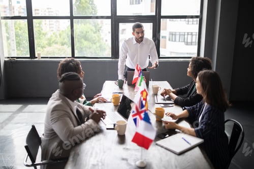 Preview: International team collaborating in a modern corporate office setting