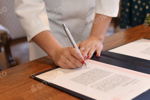 Preview: Bride signs documents