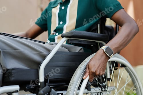 Preview: Close Up of Man using Wheelchair Hands on Wheel