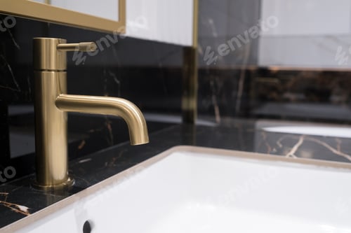 Preview: Bronze water faucet and white pedestal sink in bathroom. Stylish bathroom