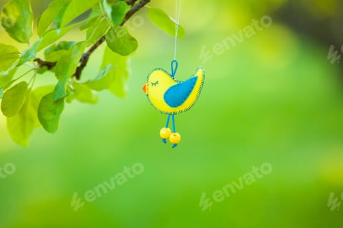 Preview: Felt bird on a green background, on an apple branch, ecology, needlework, with your own hands