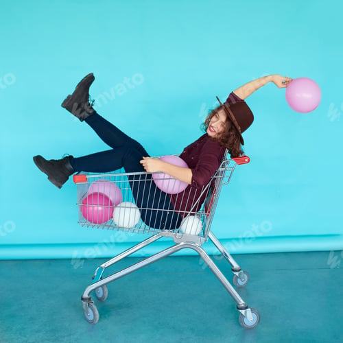 Preview: smiling fashion brunette girl sitting in shopping cart