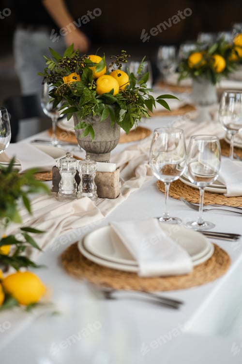 Preview: Festive table at the wedding party decorated with lemon arrangements