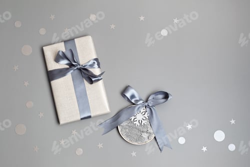 Preview: Christmas background with gift box in gray colors. Xmas celebration idea