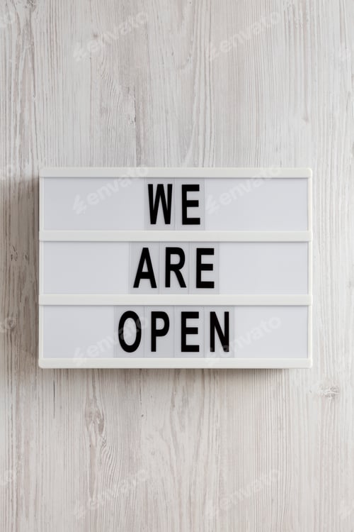 Preview: 'We are open' text on a modern board, top view. Flat lay, overhead, from above.