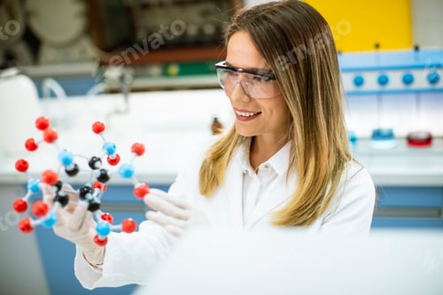 Preview: Female chemist hold molecular model in the lab