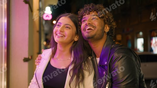 Preview: Happy talking smiling Arabian Indian couple man woman boyfriend guy girlfriend girl with shopping