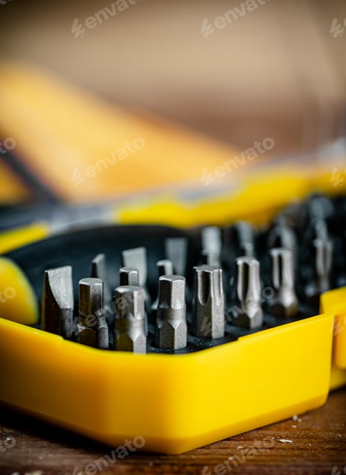 Preview: Working tools. Screwdriver bits. On a wooden background.