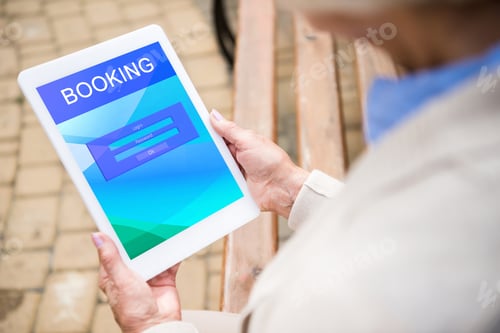 Preview: selective focus of senior woman using digital laptop with booking on screen