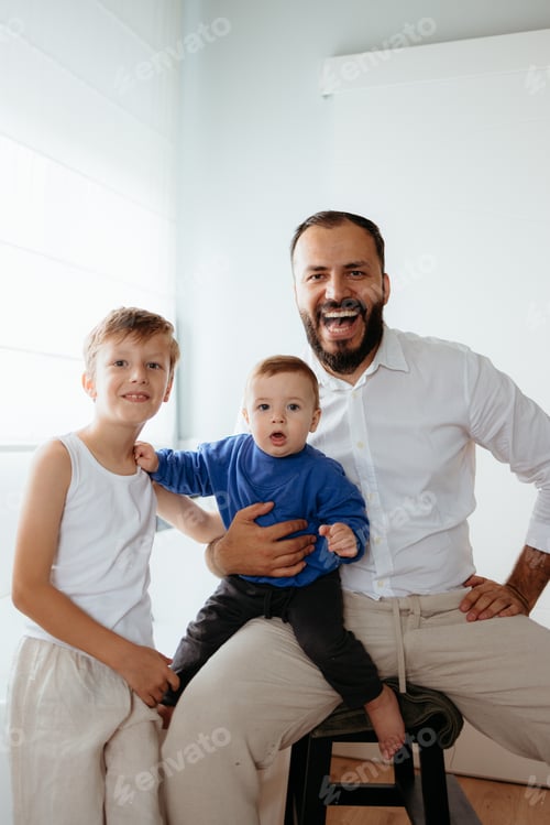 Preview: Happy father with two sons laughing