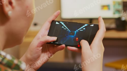 Preview: Back view of woman playing shooter games