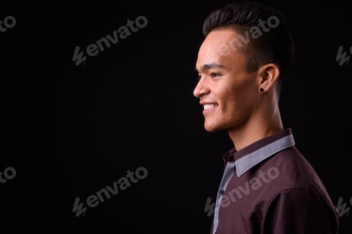 Preview: Closeup profile view of young handsome Indian businessman