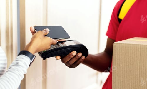 Preview: Unrecognizable Black Woman Paying For Delivered Parcel Using Smartphone Indoor