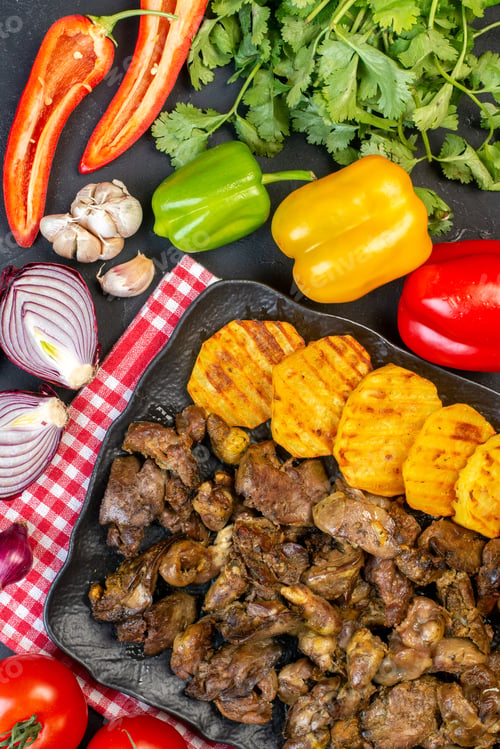 Preview: top view tasty kebab with potato on platter red onions tomatoes bell peppers coriander garlic on