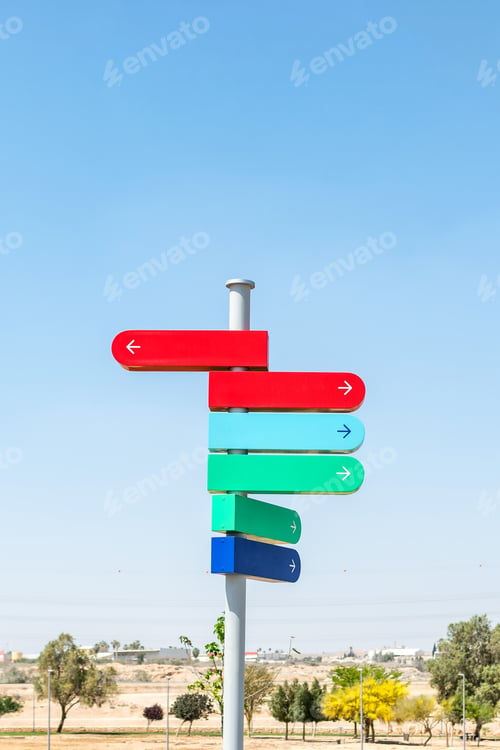 Preview: Blank signpost with many directions against blue sky in sunny day. Mockup. copy space.