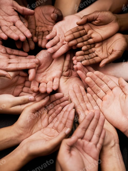 Preview: We need your support. Shot of a group of hands held cupped out together.