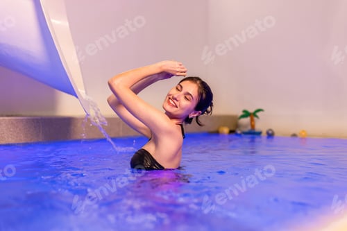 Preview: beautiful woman in swimwear relaxing in swimming pool spa.