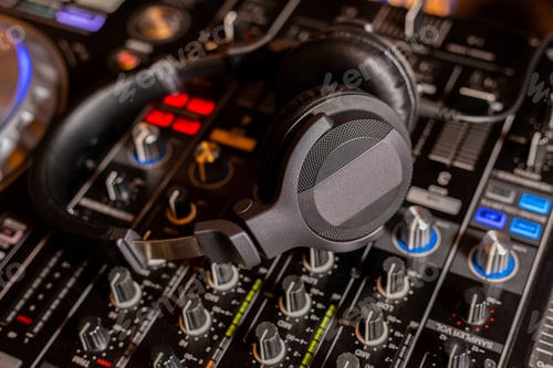 Preview: Headphones on dj console deck Big dj headphones