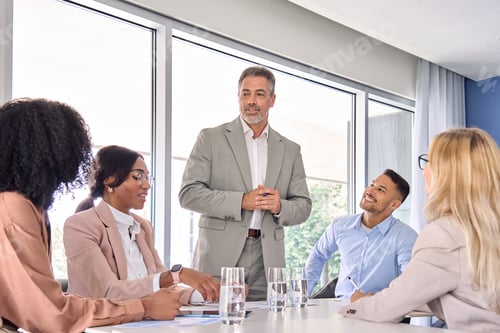 Preview: Happy leader and company employees at business meeting discussing work plan.