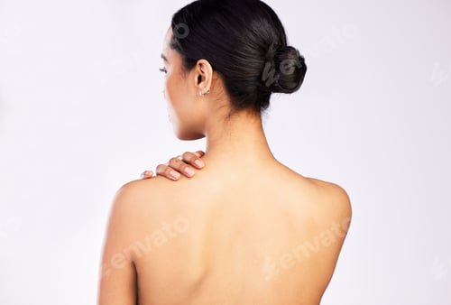 Preview: Be kind to your body. Rearview shot of a young woman posing with her hand on her shoulder.