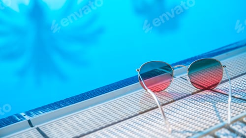 Preview: Sunglasses on pool background, reflection of palm trees, travel concept, relaxation