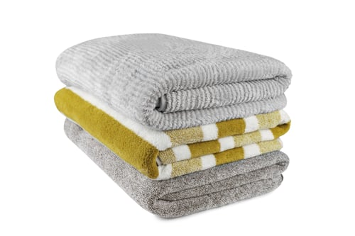 Preview: Soft Fluffy Striped Grey And Yellow Bath Towels Folded In Stack Isolated On White Background