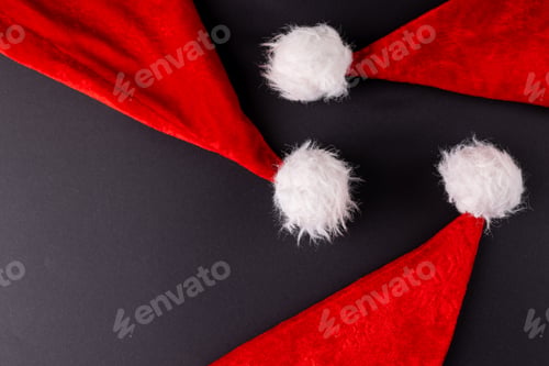 Preview: Image of santa claus hats lying on dark grey surface