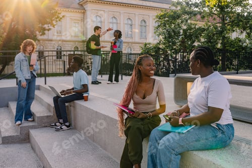 Preview: Diverse students sitting and standing on stairs at campus during break
