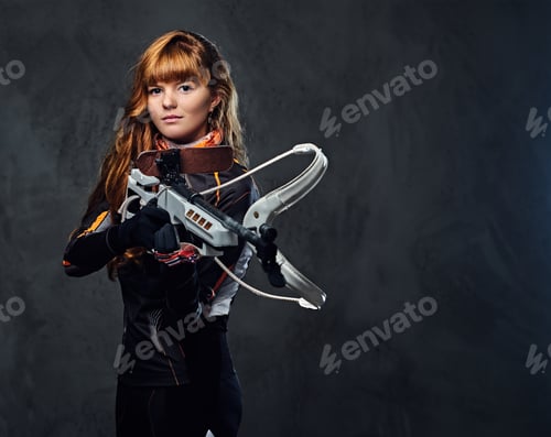 Preview: Redhead female Biathlon champion aiming with a competitive gun.