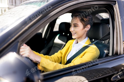 Preview: Beautiful young woman with short hair drives car in the city