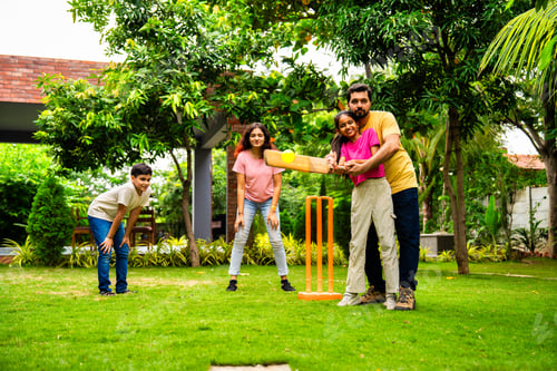 Preview: Indian Asian family bonding through outdoor cricket batting in garden, enjoying fun and play