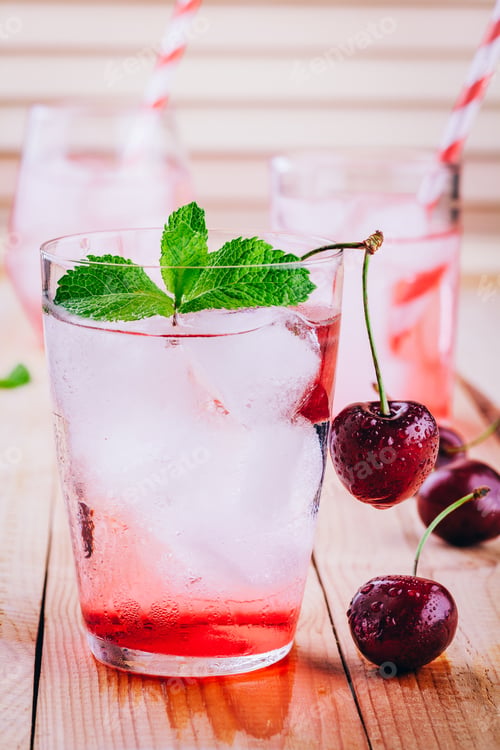 Preview: ice refreshing cherry lemonade in glass with ice cubes and mint
