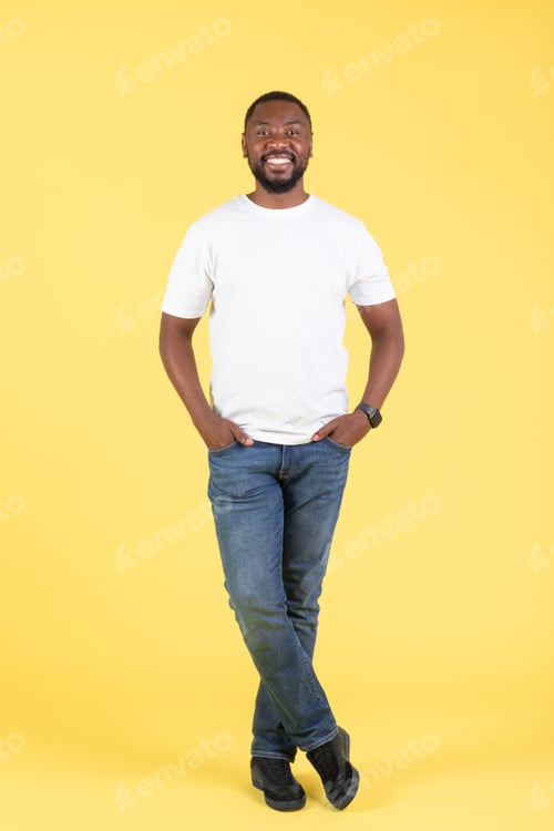 Preview: Handsome Black Male Smiling Standing Over Yellow Studio Background