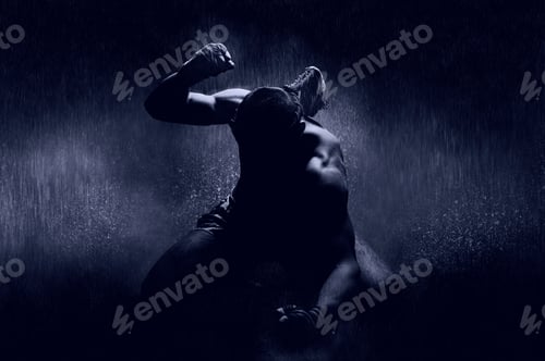 Preview: Thai Boxer In The Rain And Under A Blue Spotlight. Mongkhon. The Concept Of Victory In