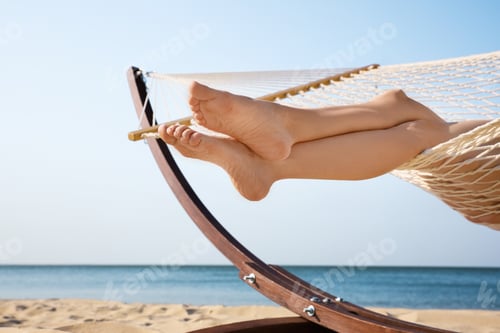 Preview: Young woman resting in hammock on beach, closeup