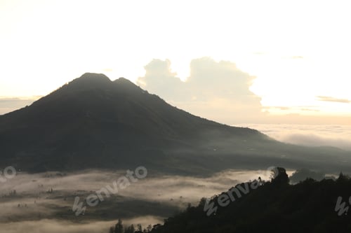 Preview: Picturesque view of mountains covered with fog on sunset