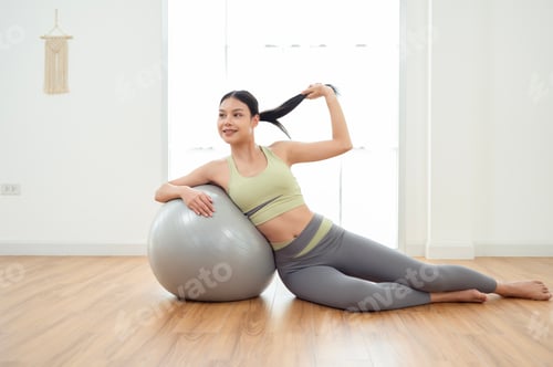 Preview: Woman Relaxing after Workout with Exercise Ball
