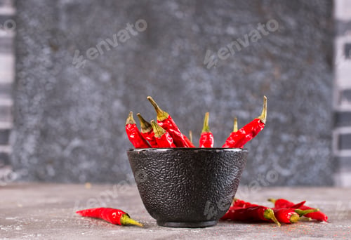 Preview: bowl with chilli pepper on gray background