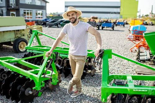 Preview: Agronomist at the shop ground with agricultural machinery