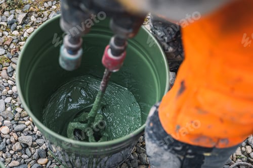 Preview: Skilled worker mixes epoxy resin paint