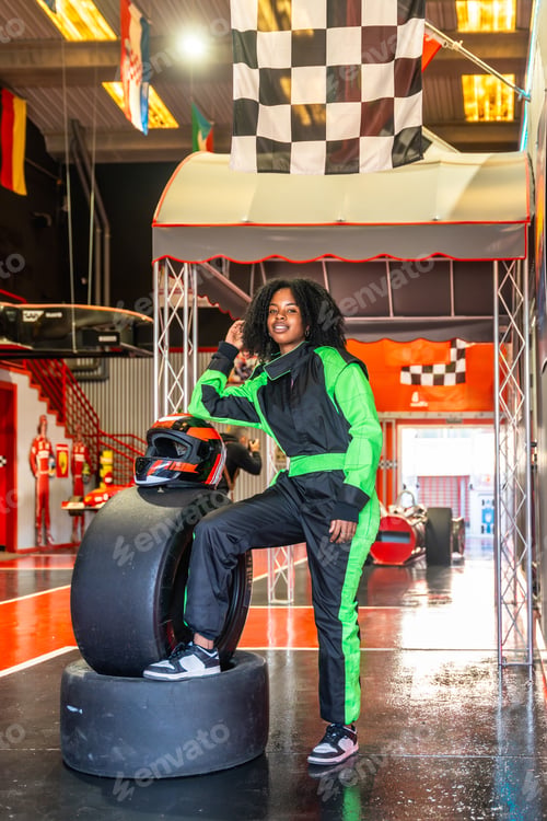 Preview: Young woman enjoying karting experience wearing race suit