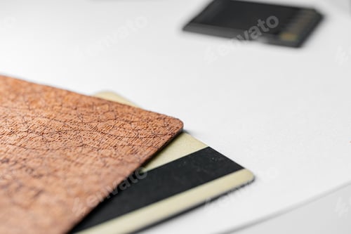 Preview: Stack of textured brown, black, and white cards on white surface