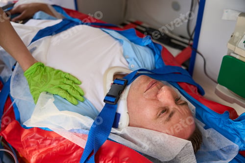 Preview: Injured man on a stretcher is loaded into an ambulance