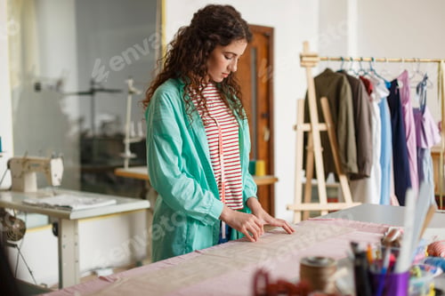 Preview: Young thoughtful designer preparing work with new textile in se