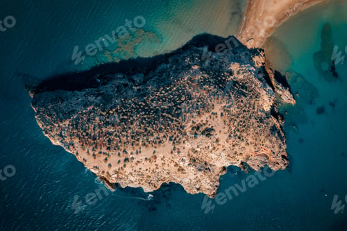 Preview: Aerial view of a small island connected with the shore surrounded by crystal blue waters