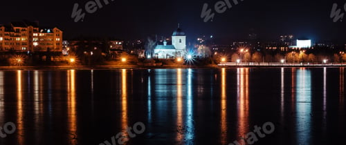 Preview: Panorama of night city lights and reflections on lake at Ternopil, Ukraine, Europe.