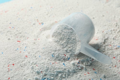 Preview: Scoop with washing powder on washing powder background