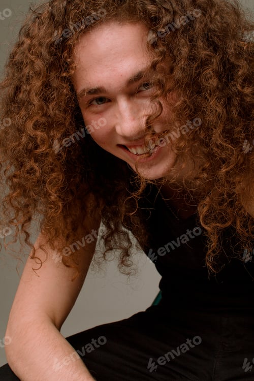 Preview: Attractive And Stylish Guy With Curly Hair And A Sports Figure